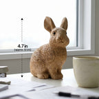 Wooden bunny figurine on a windowsill beside a mug with height labeled 4.7 inches