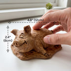Wooden pig figurine on a table with dimensions labeled 4.8 inches by 2.4 inches
