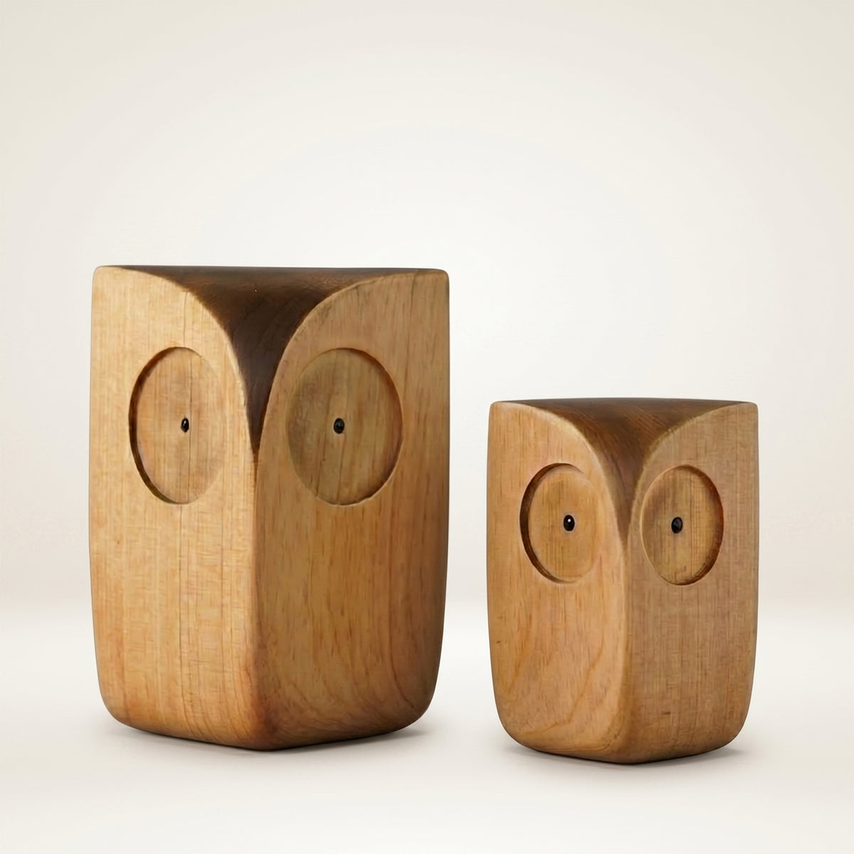Two Wooden Minimalist Owl Figurines, big and small size, side by side on a plain background