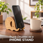Elephant coaster holder trunk used as a phone stand on a desk