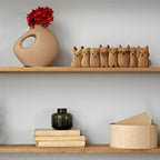 Wooden puppy row displayed on a decorative shelf arrangement